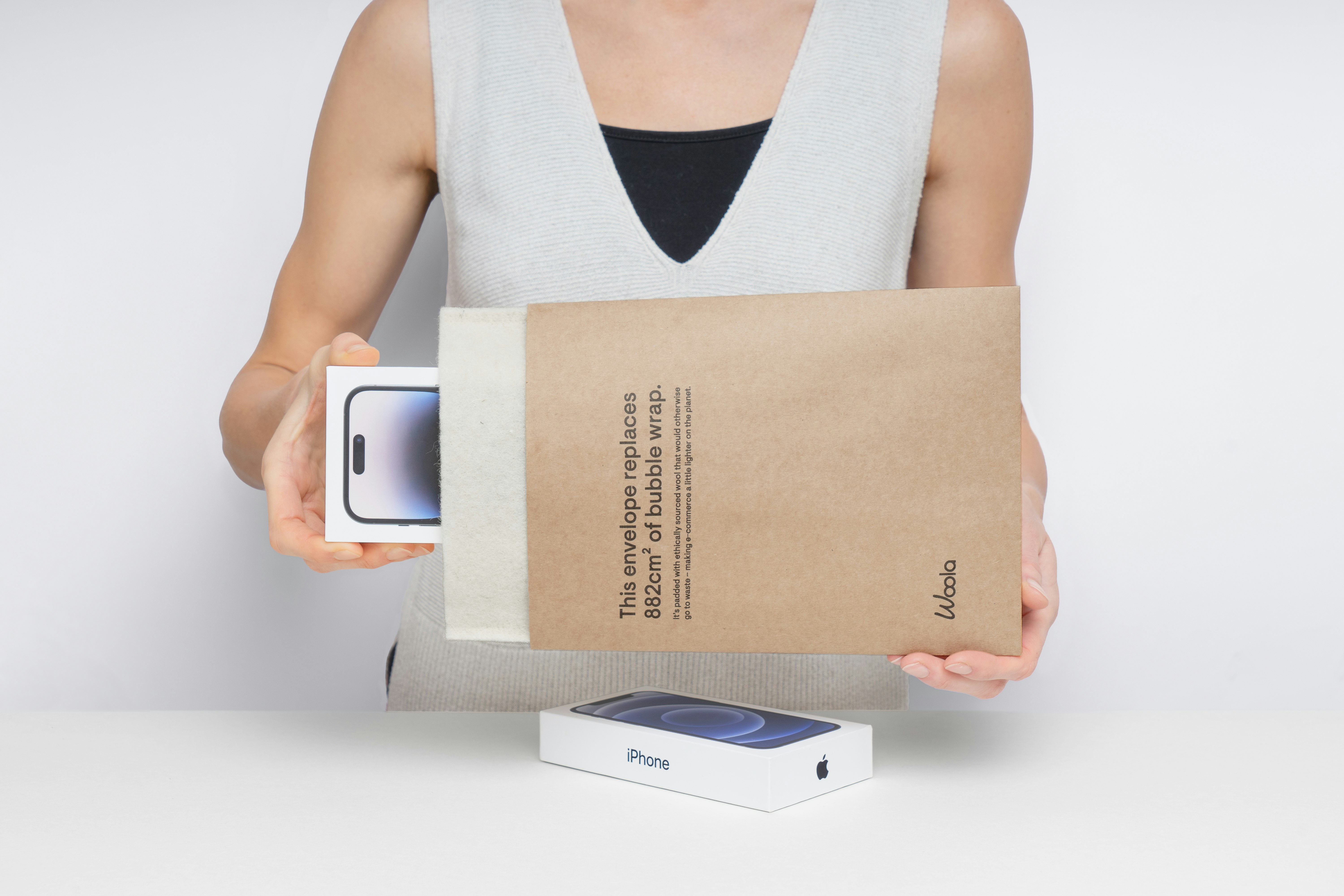 Person holding a new smartphone in packaging.